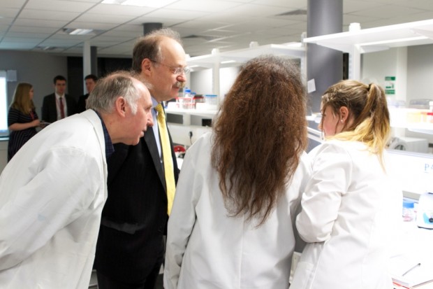 Sir Mark views a student's experiment