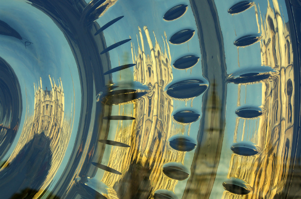 Cambridge reflected in the golden face of the 'Chronophage' clock. (credit: Tanya Hart/CC BY-SA 2.0)